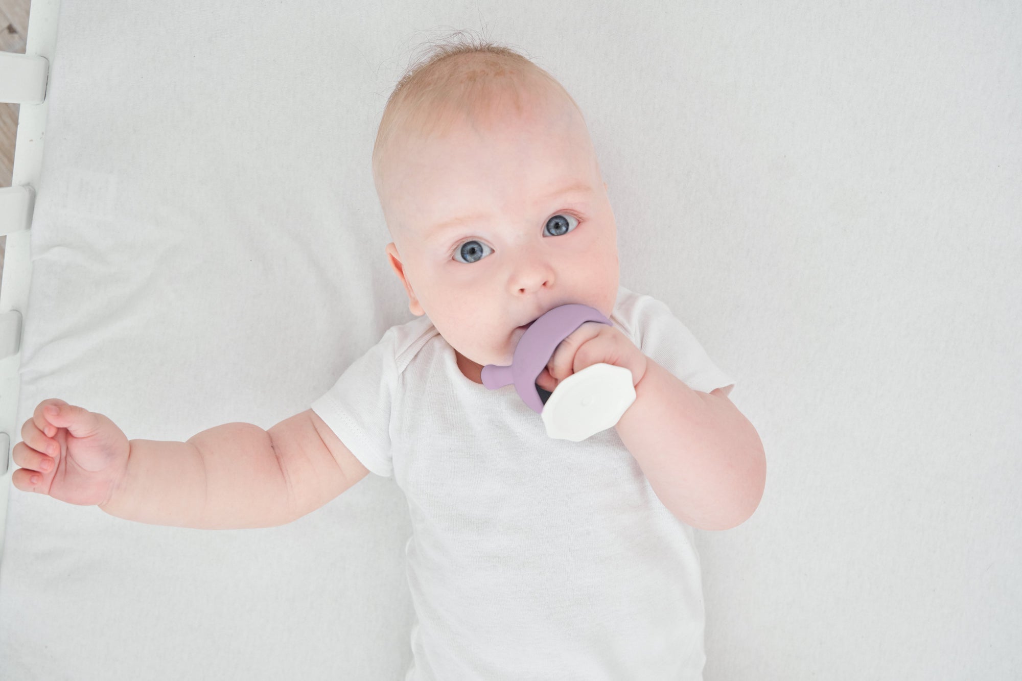 En myk lavendel og hvit silikon babyteether med rundt ergonomisk design som sopp lavendel og tåler oppvaskmaskin
