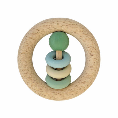 A natural wood baby rattle ringrangle grønn with light green sphere and pastel rings on a central stick