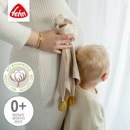 Soft beige koseklut i økologisk bomull med hvit sau i myk plush og gule dusker