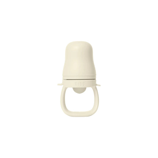 Cream-colored minimalist silicone baby feeder matsmokk ivory with rounded top and handle for baby utforske fast føde