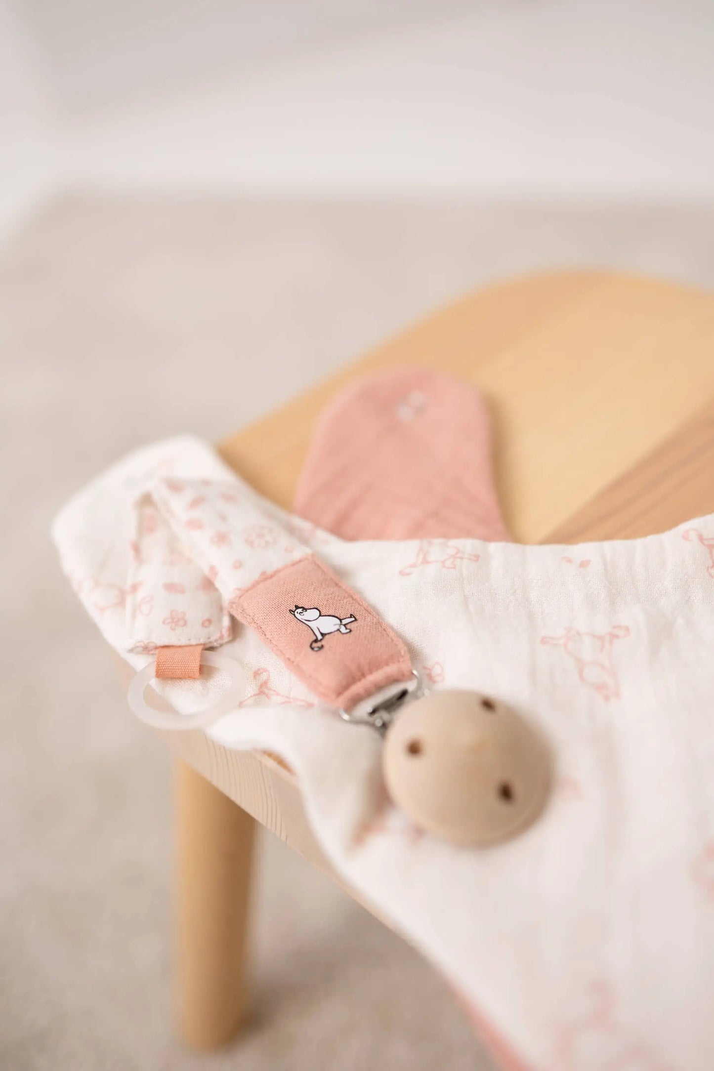 Moomin smokkelenke rosa holder smokken med praktisk klips i økologisk bomull med rosa blomstermønster